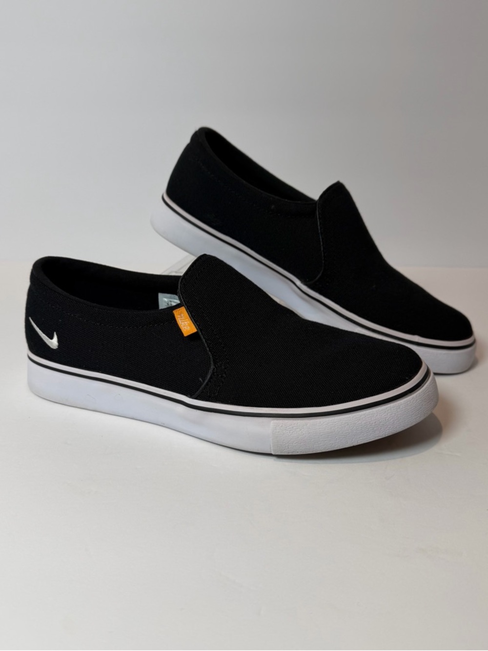 Nike Women’s Black Canvas Slip-On Sneakers with White Sole Size: 6.5